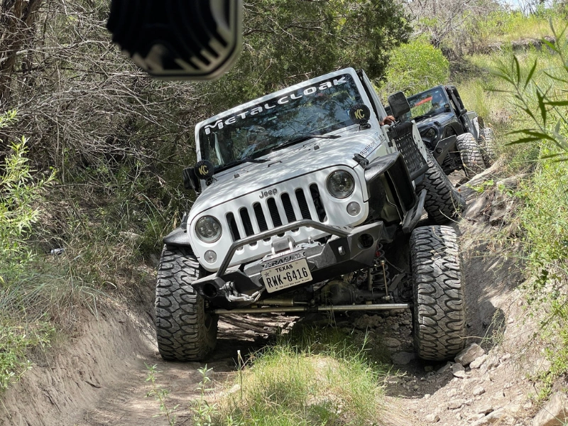 Lifted Jeep Wrangler rock crawling on Texas trail with upgraded suspension system